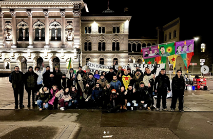 group holding up Kurdish flags